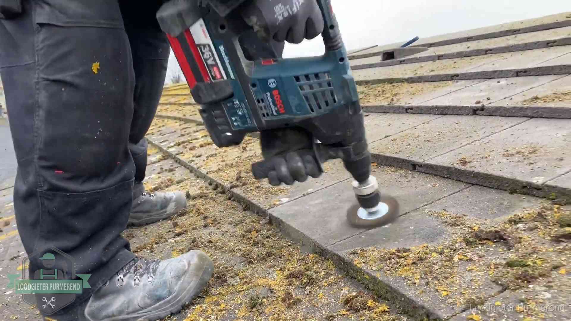 Betonnen dakpannen worden machinaal gereinigd tijdens dakonderhoud in Purmerend