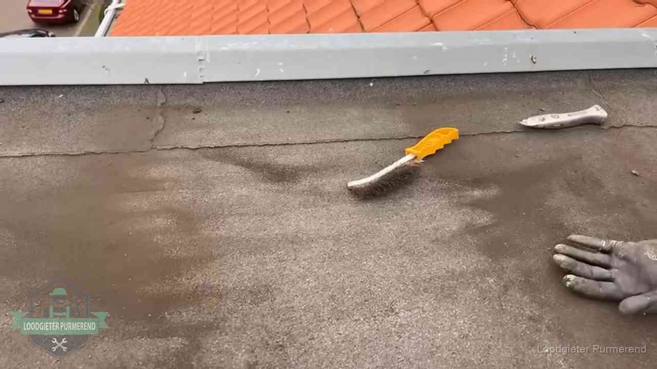 Dakdekker bereidt een bitumen plat dak voor op reparatie bij de daktrim in Purmerend